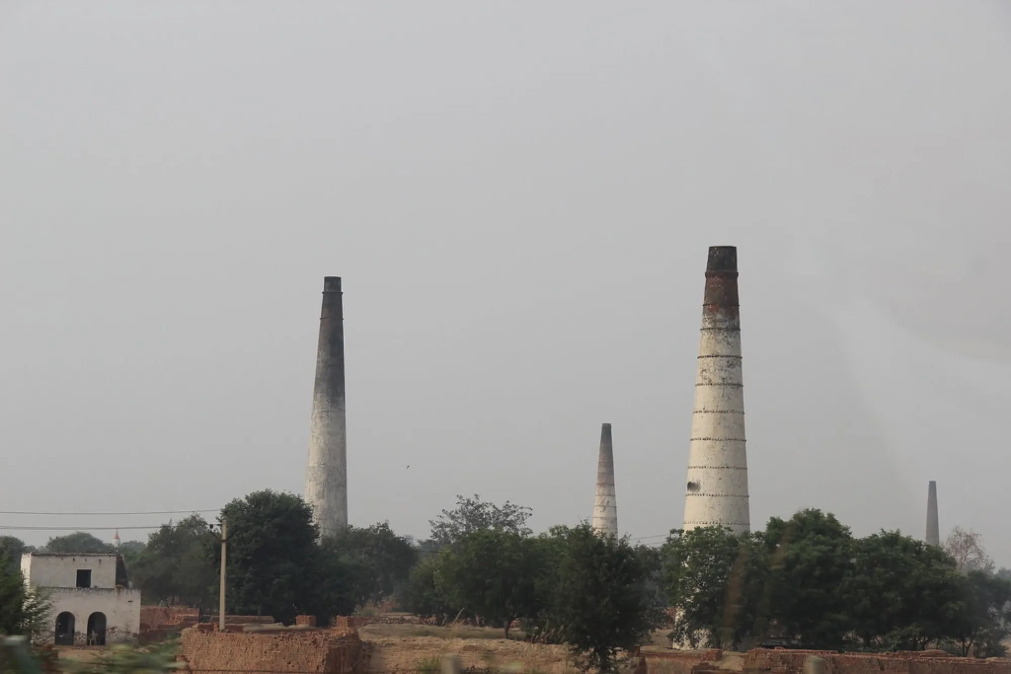 Brick kiln chimneys on the horizon