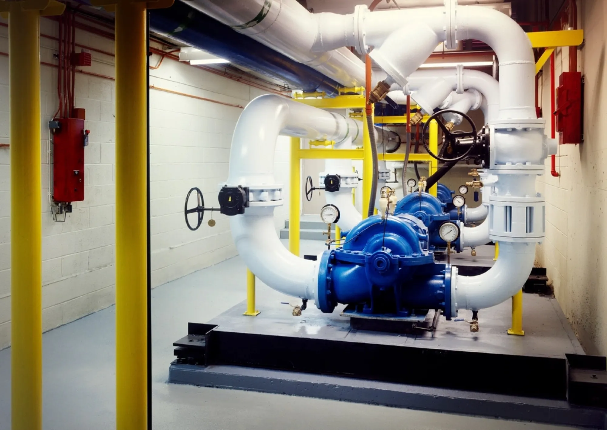 Boiler room with pumps, valves and insulated pipework