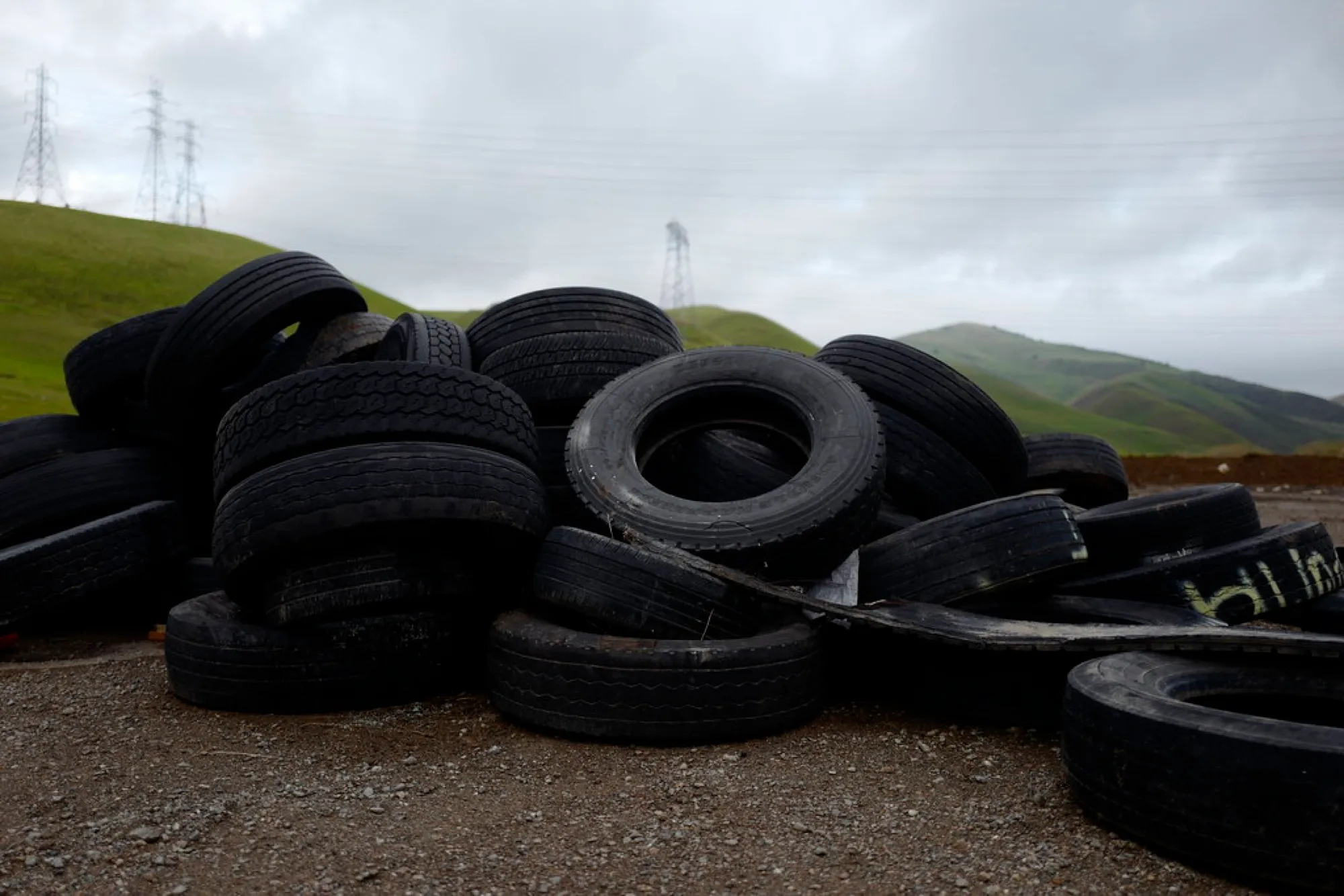 Large stockpile of discarded tyres in an open field